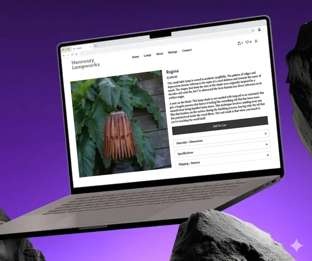 Laptop showing a product page for Rugosa lamp on Hennessy Lampworks website with Add to Cart and expandable sections, set on a purple background outside a rocky scene.