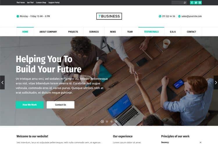Hero section: a team collaborates around a wooden table with laptops, viewed from above, for a business website header.